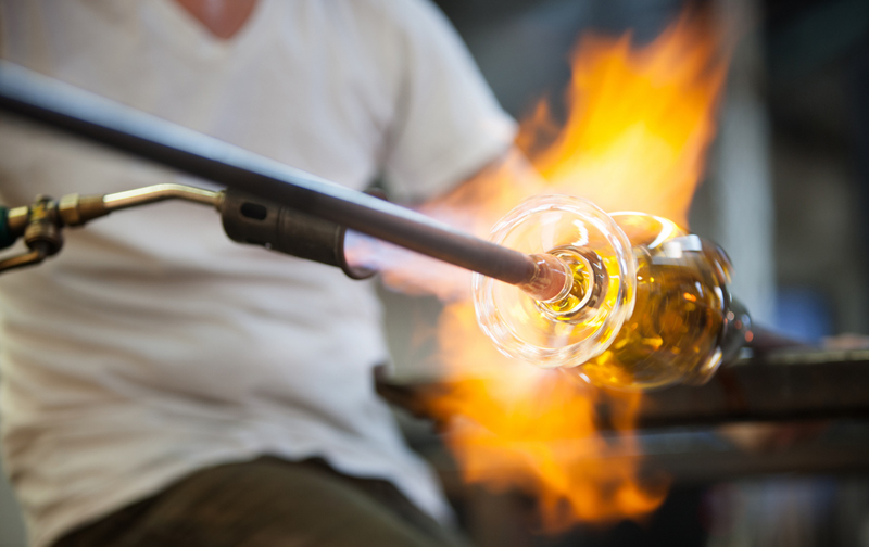 A Glass Blower Works On A Glass Of Wine
