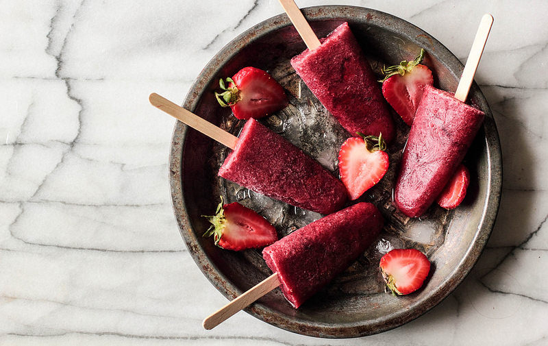 These are roasted strawberry red wine popsicles