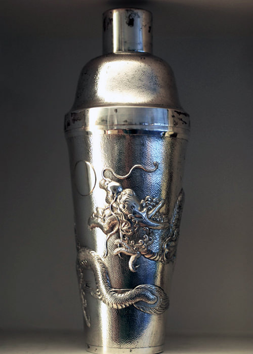 This is an antique silver cocktail shaker