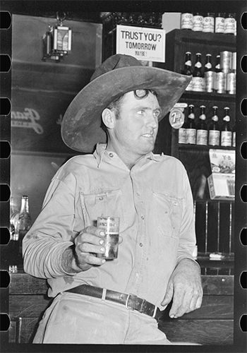 Cowboy drinking beer in beer parlor