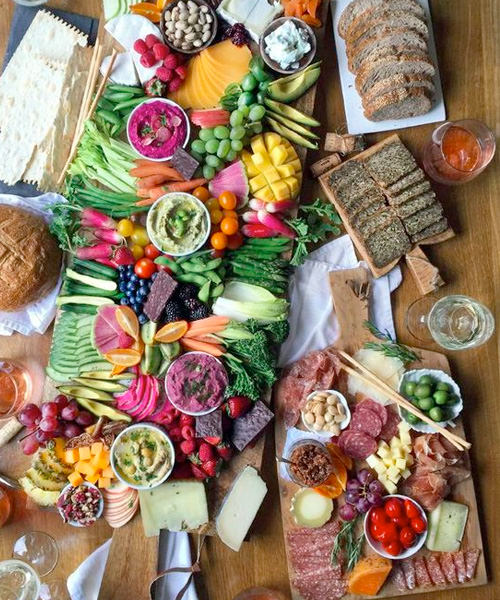 We're Obsessed With These 15 Swoon-Worthy Cheese & Charcuterie Boards Bright Breathtaking Colorful Cheeseboard Carrots Avocado Vegan Gluten Free Bread Crackers Olives